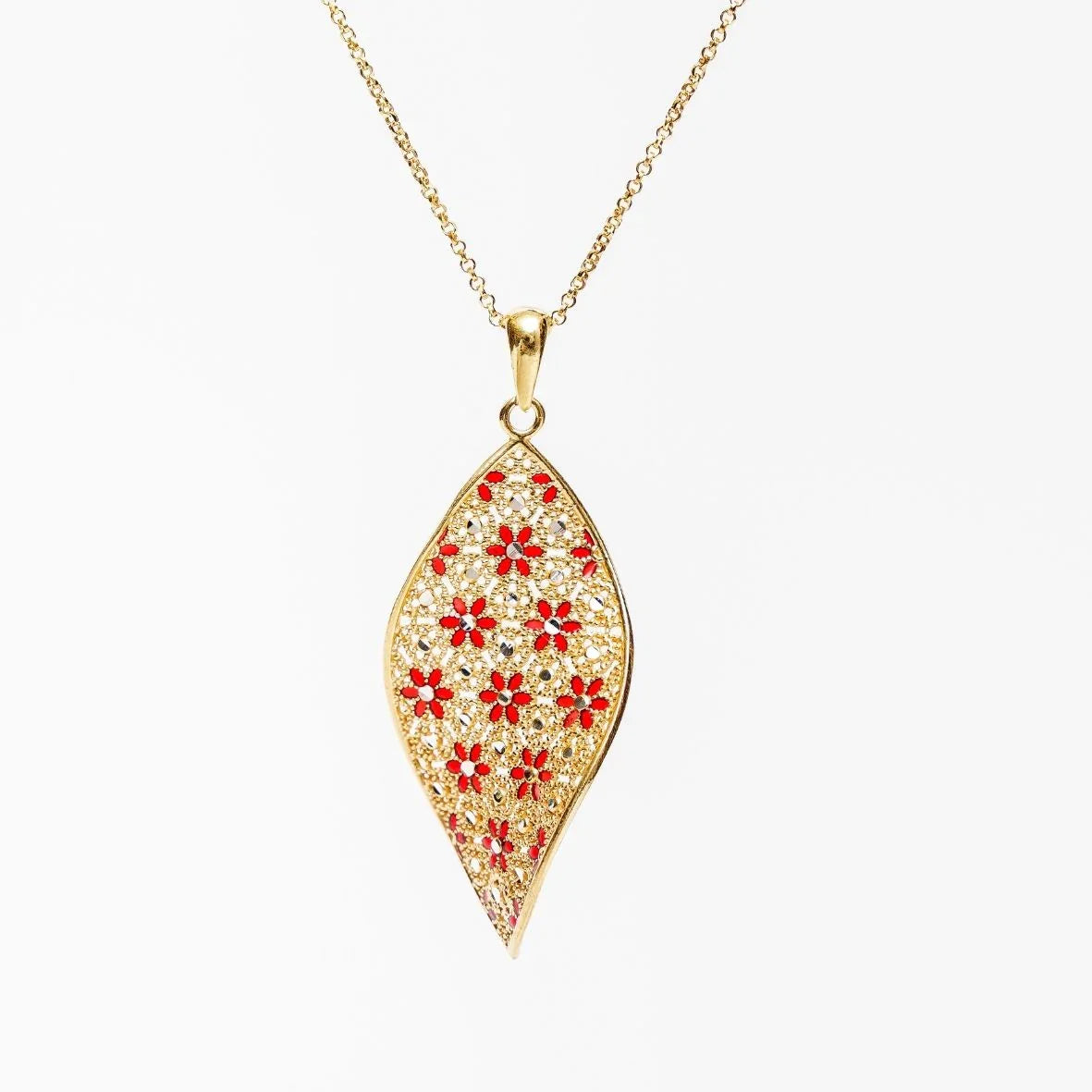 Gold filigree leaf-shaped pendant necklace with red floral accents on white background