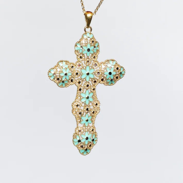 Gold filigree cross pendant necklace with turquoise flower accents on white background