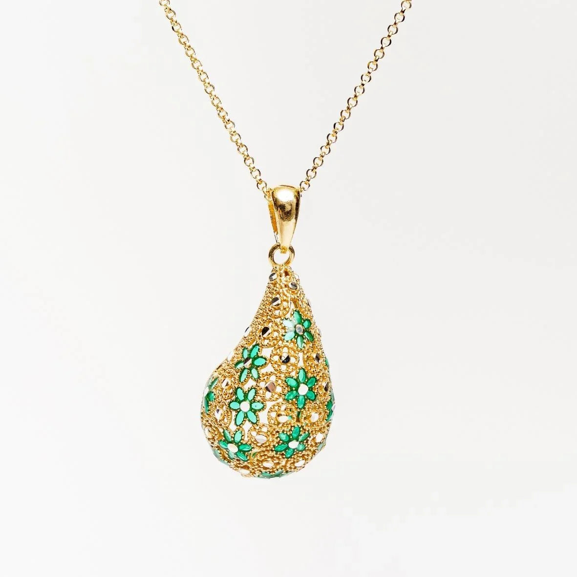 Gold floral teardrop pendant necklace with green enamel flowers on a gold chain
