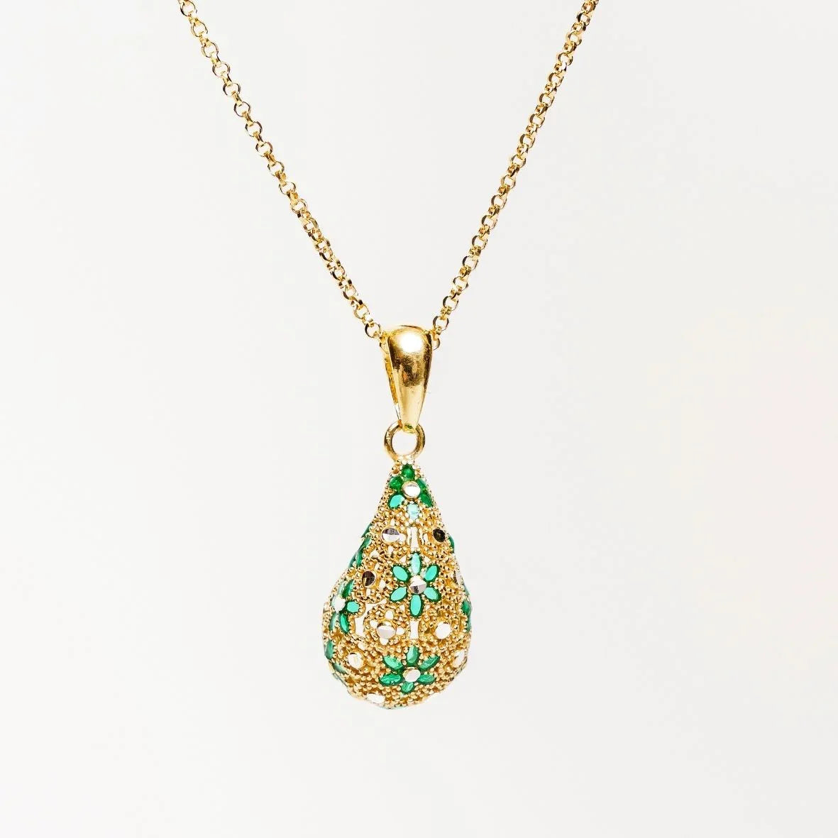 Gold filigree teardrop pendant necklace with green floral accents on chain