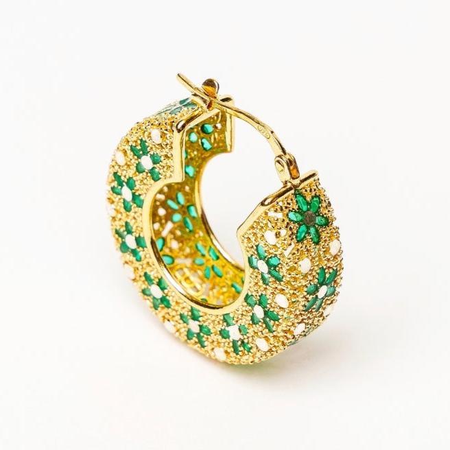 Gold hoop earring with intricate floral design featuring green enamel and textured details