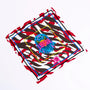 Colorful scarf with blue eagle head and text 'LIBERA' on red, white, and brown abstract pattern background