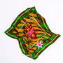 Colorful silk scarf with green, brown, and orange tiger stripe pattern and pink CHIC logo