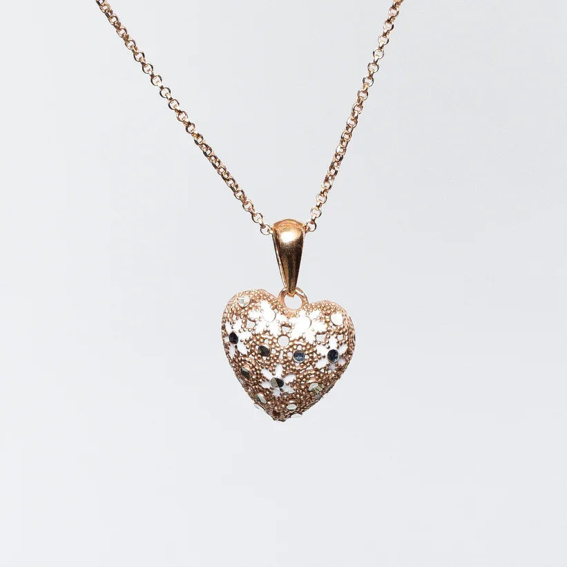 Rose gold heart-shaped pendant necklace with textured floral design and small dark gemstones