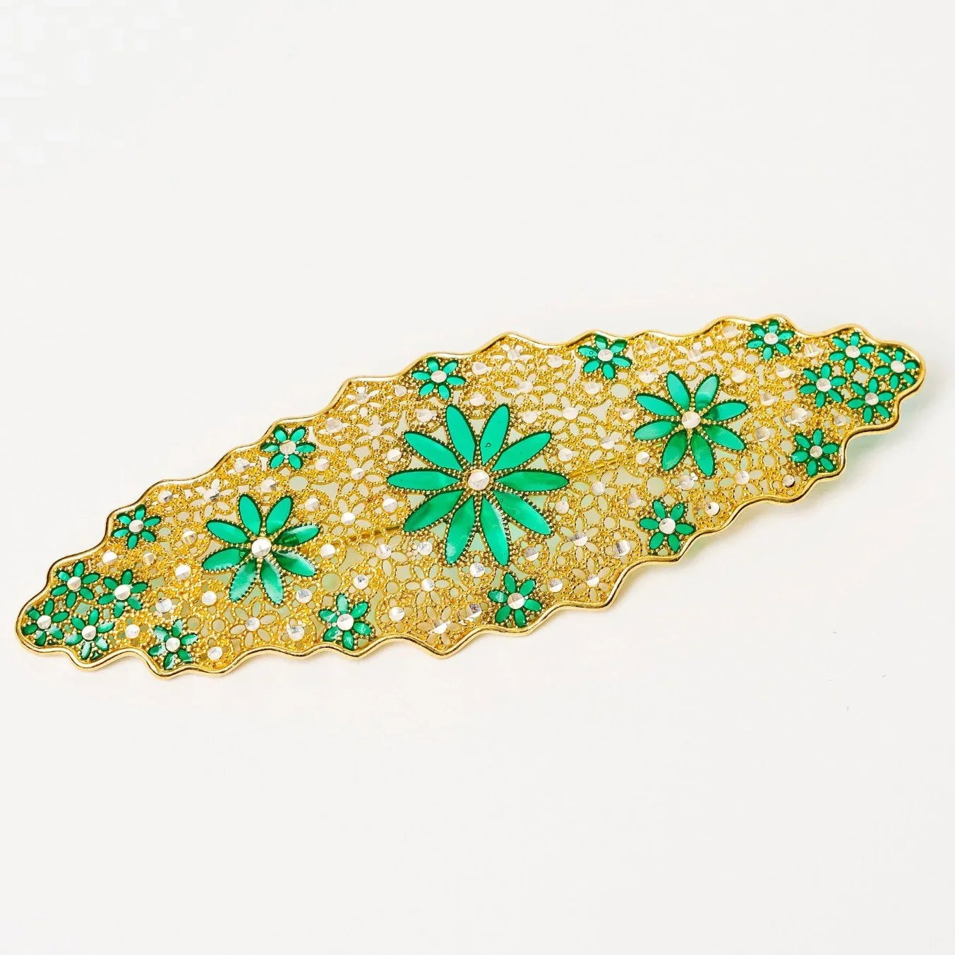 Gold filigree hair clip with green enamel floral accents and rhinestone details