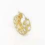 Gold hoop earring with intricate floral filigree and white enamel flower accents