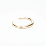 Minimalist polished solid gold cuff bracelet on white background