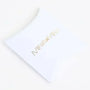 White pillow box packaging with gold metallic text and star logo