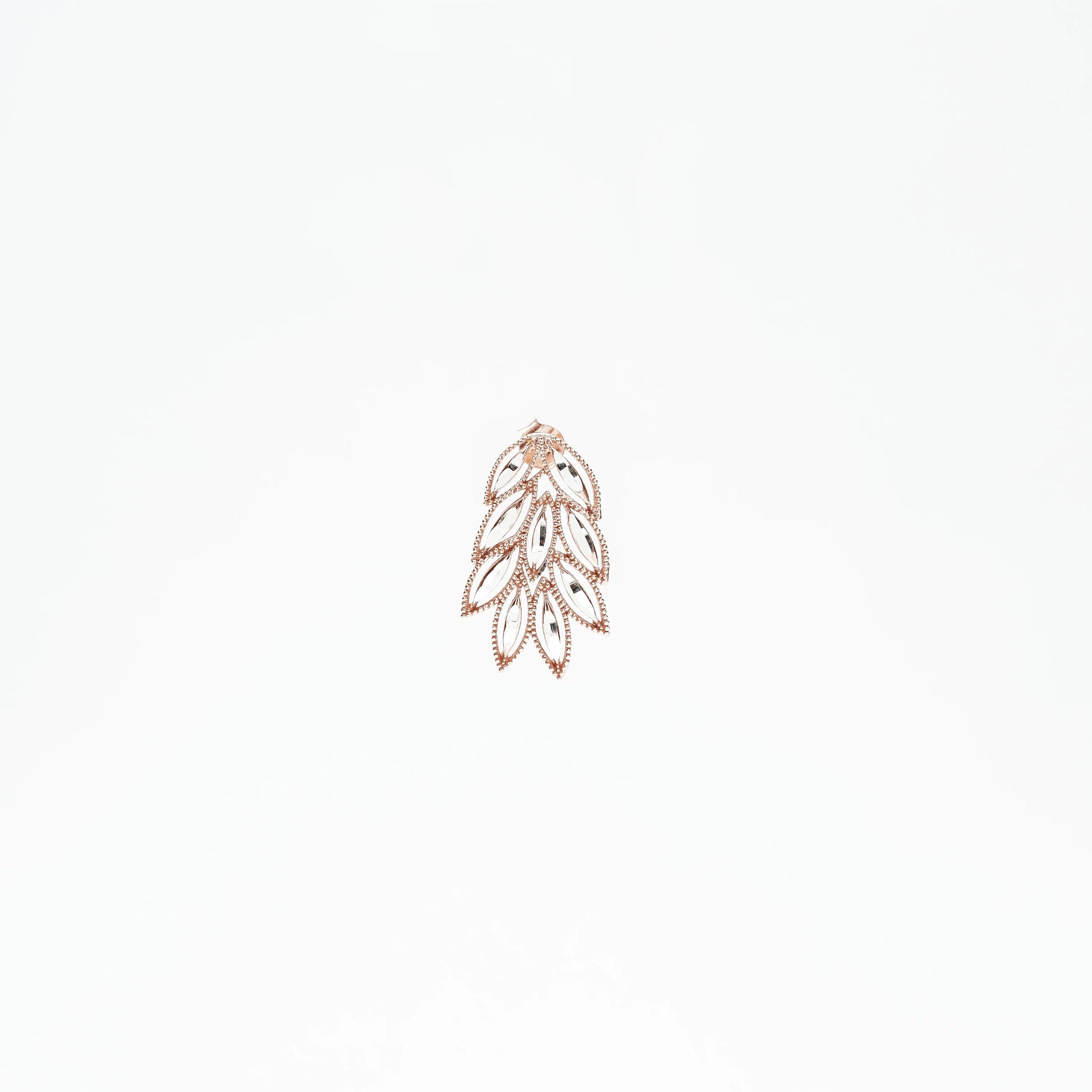 Rose gold leaf-shaped dangling earring with crystal accents on white background