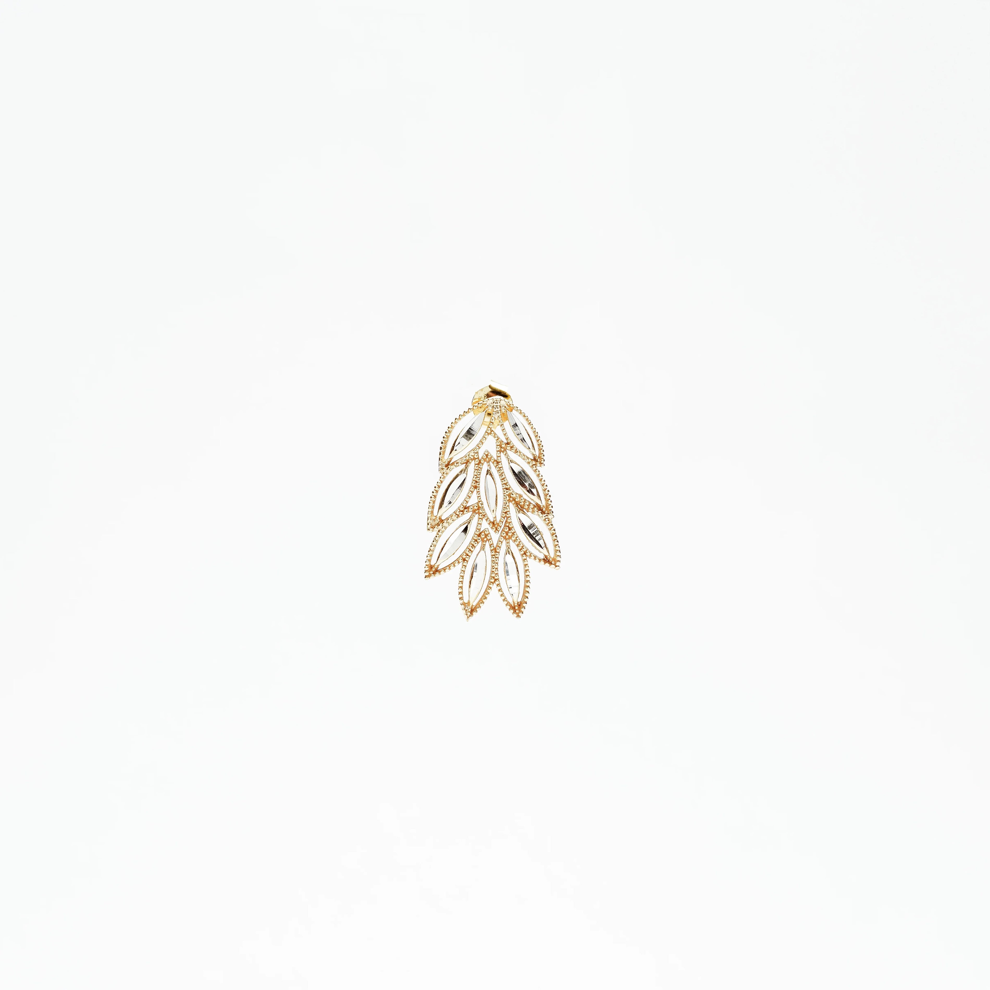 Gold and silver leaf-shaped pendant with intricate design on white background