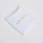 White pillow box packaging with MINA gold foil logo on plain white background