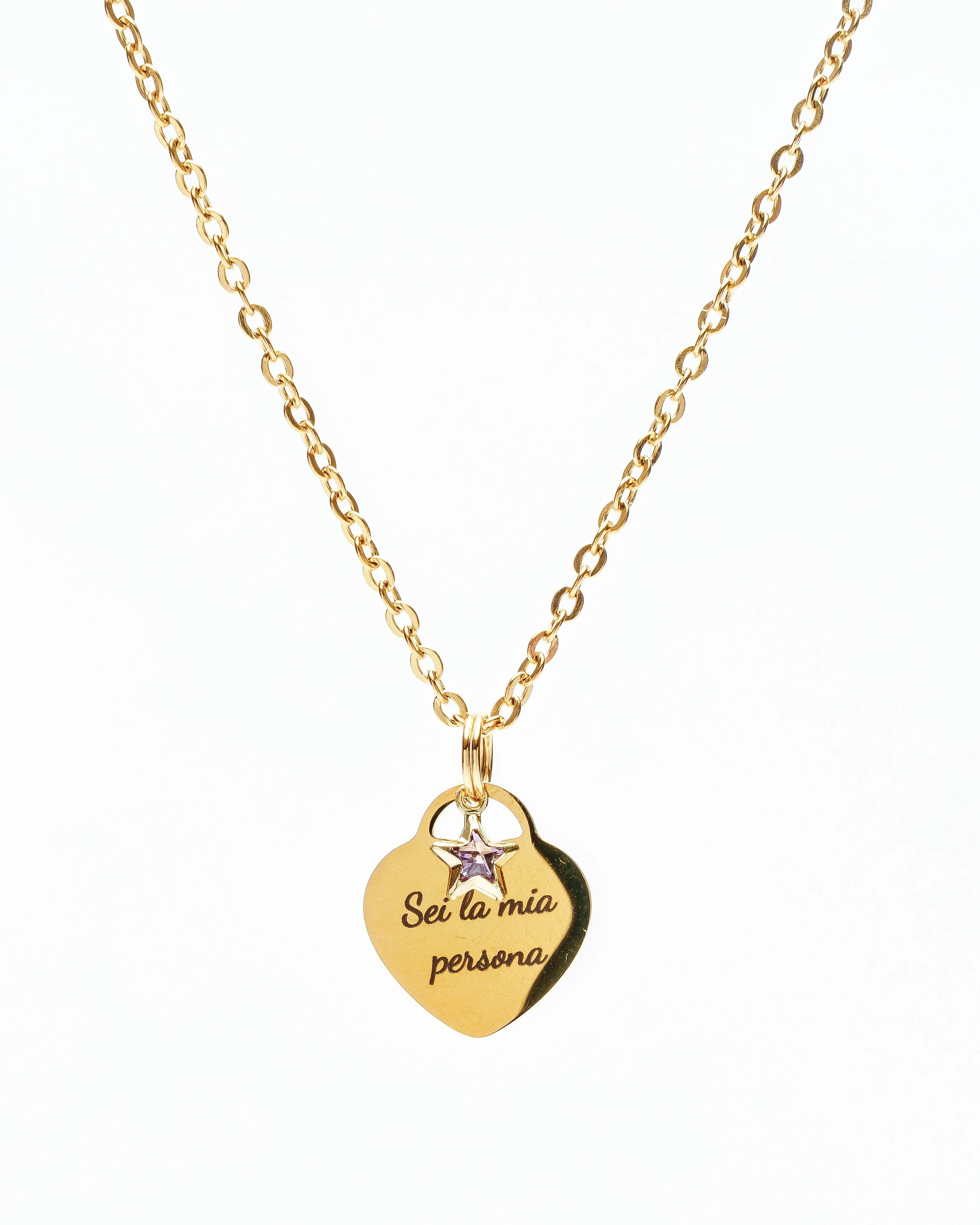 Gold necklace with heart pendant engraved Sei la mia persona and small star charm on white background