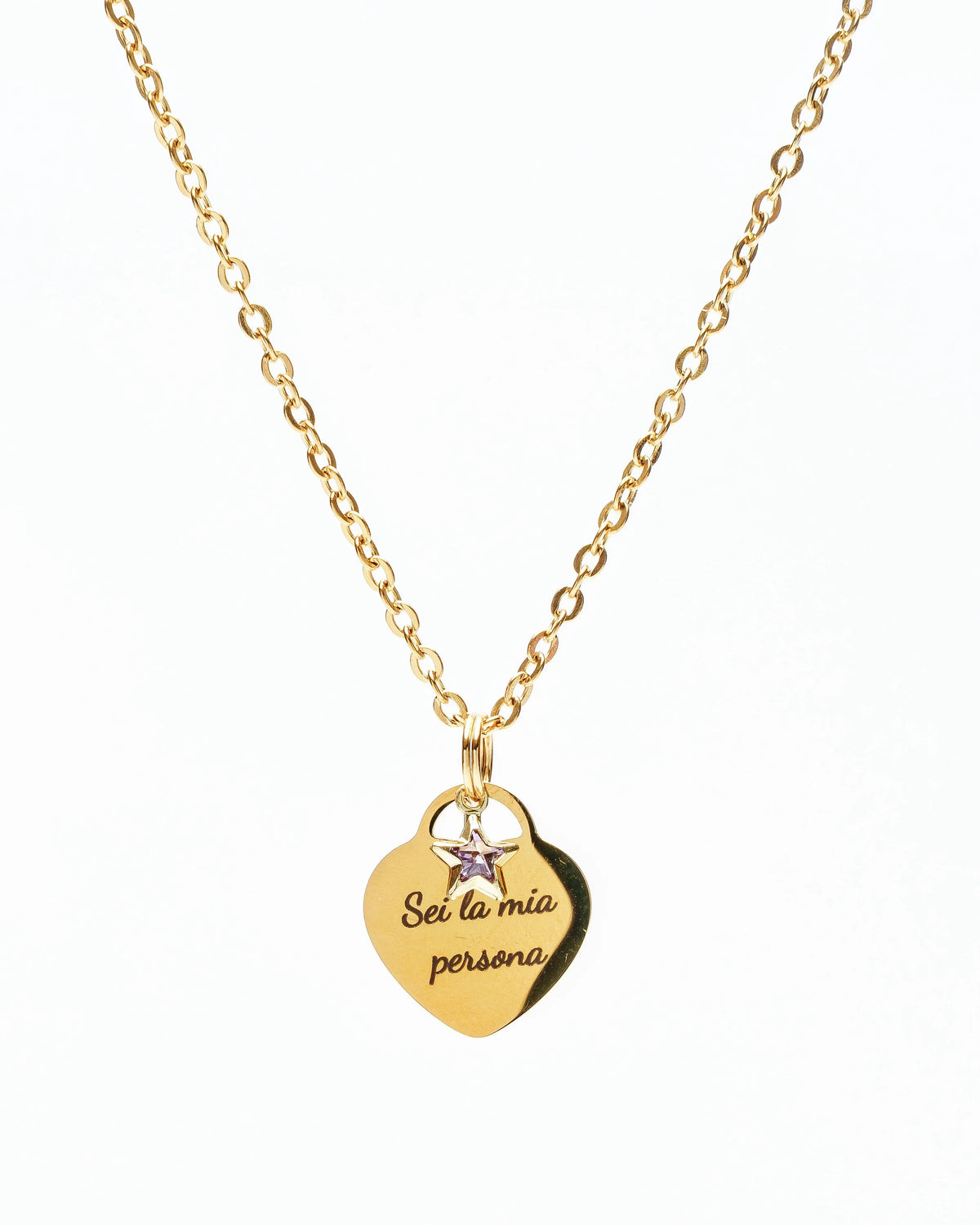 Gold necklace with heart pendant engraved Sei la mia persona and small star charm on white background