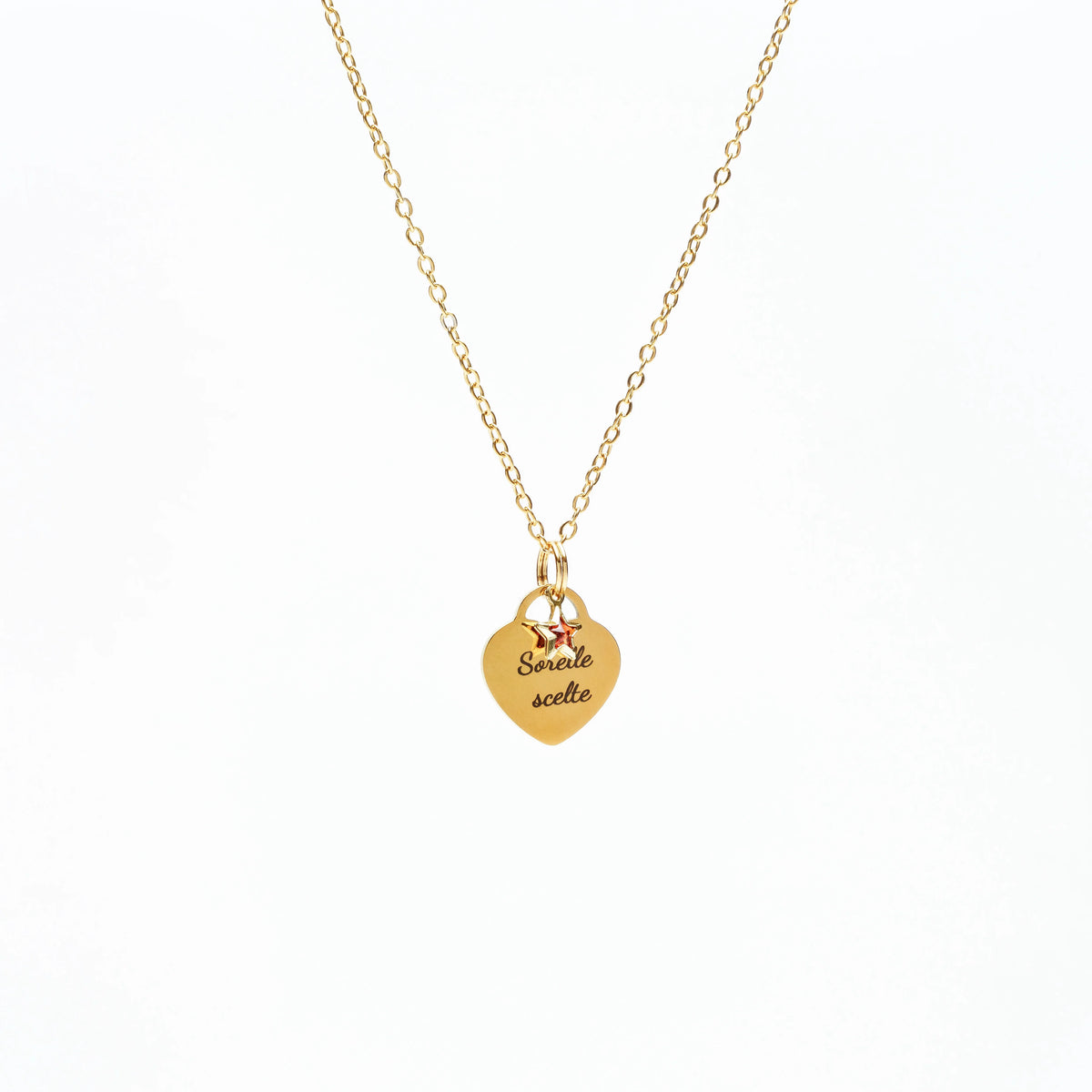 Gold heart pendant necklace with engraved text "Sorelle scelte" and two small star charms