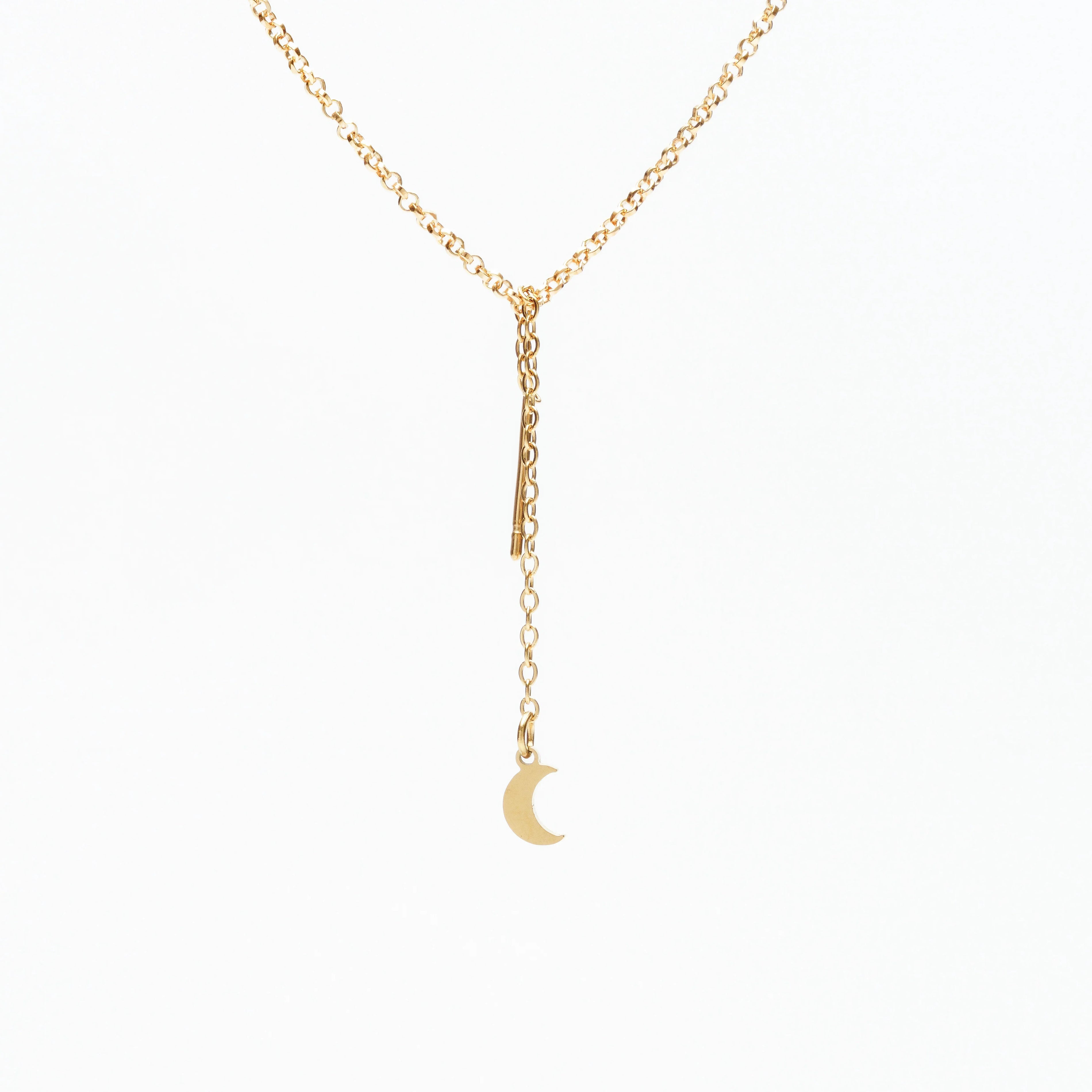 Delicate gold chain necklace with small crescent moon pendant on white background