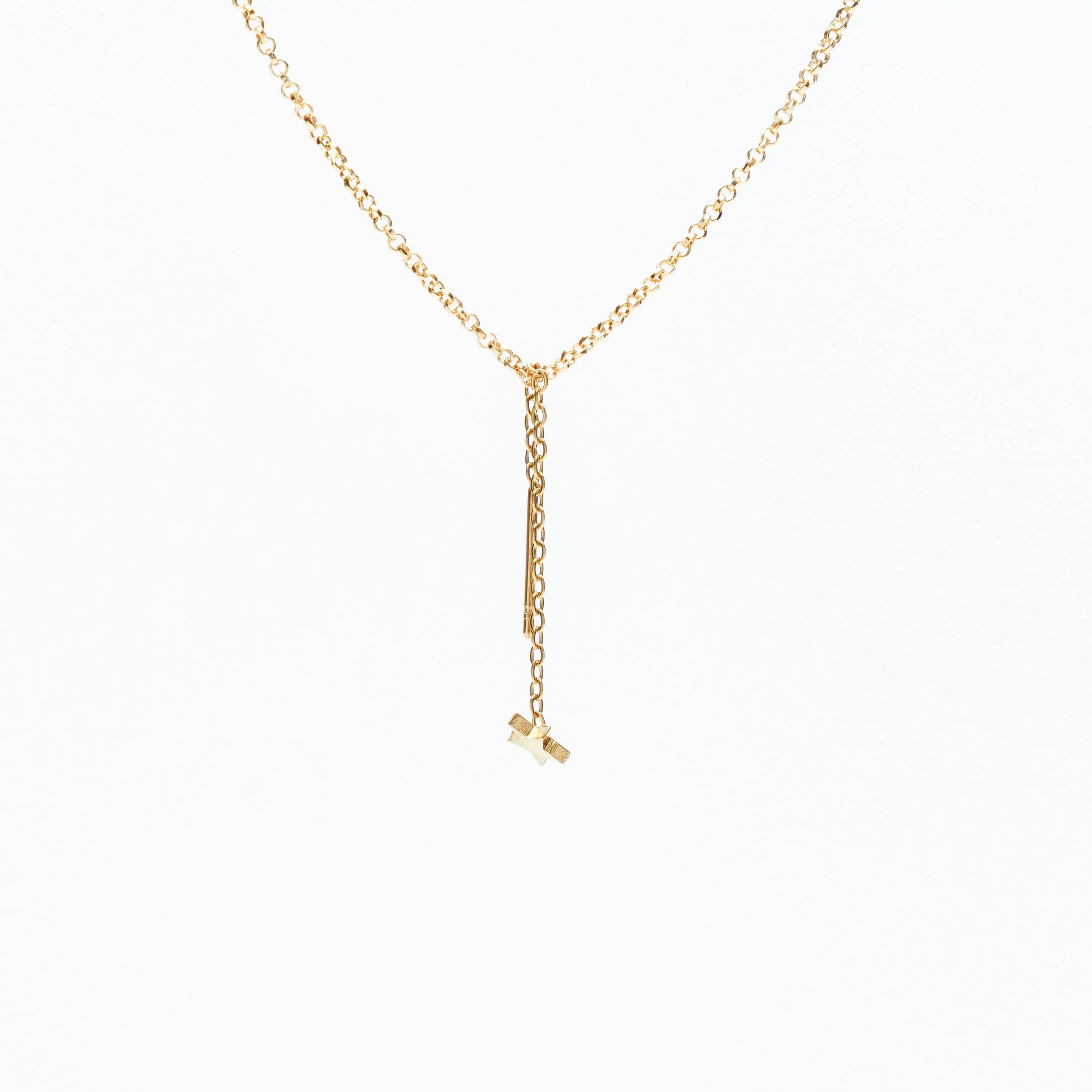 Delicate gold chain necklace with a dangling star charm on a white background