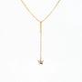 Delicate gold chain necklace with a small butterfly pendant on white background