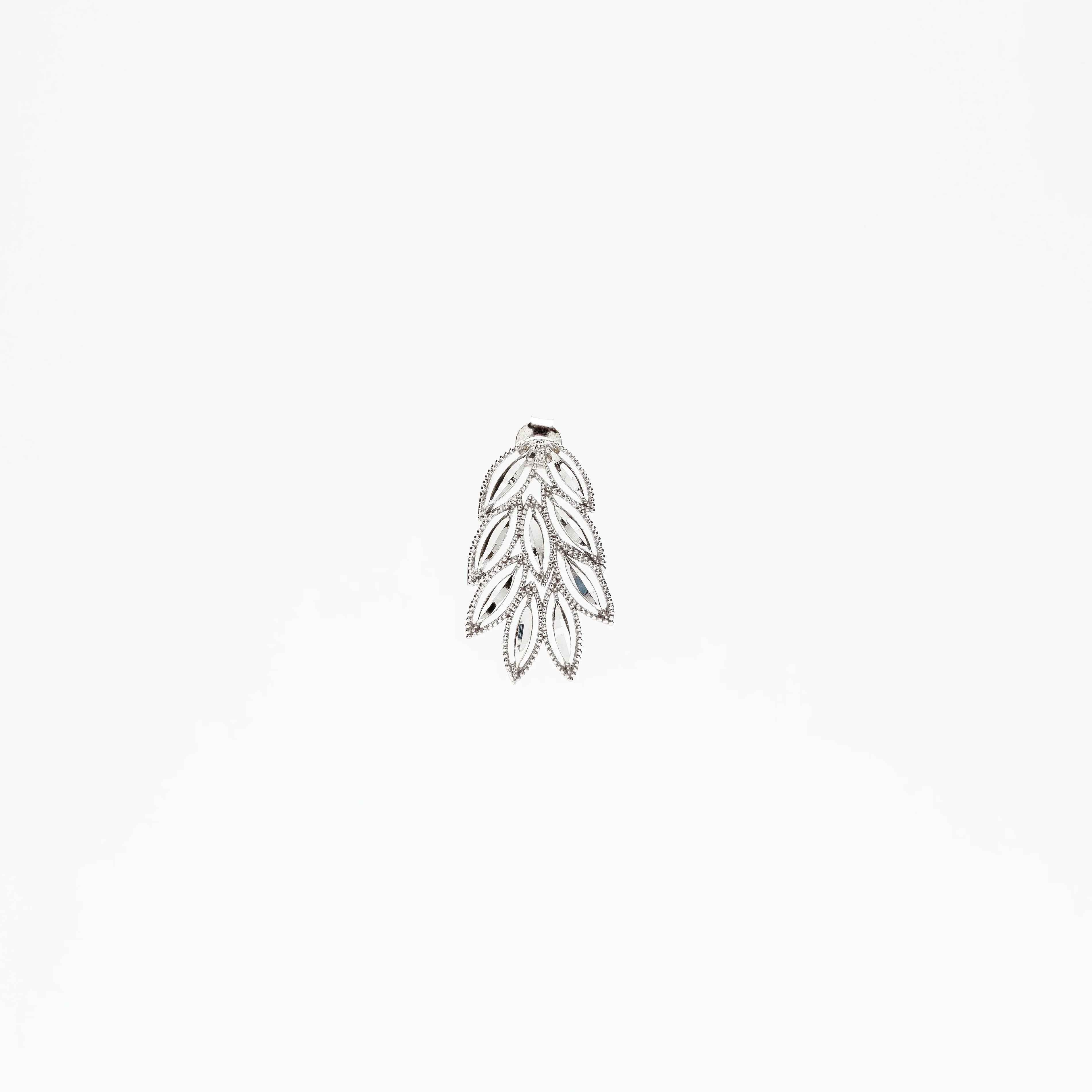 Silver leaf-shaped pendant with intricate openwork and small crystals on white background