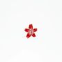 Red flower enamel pin with five petals and a silver center on white background
