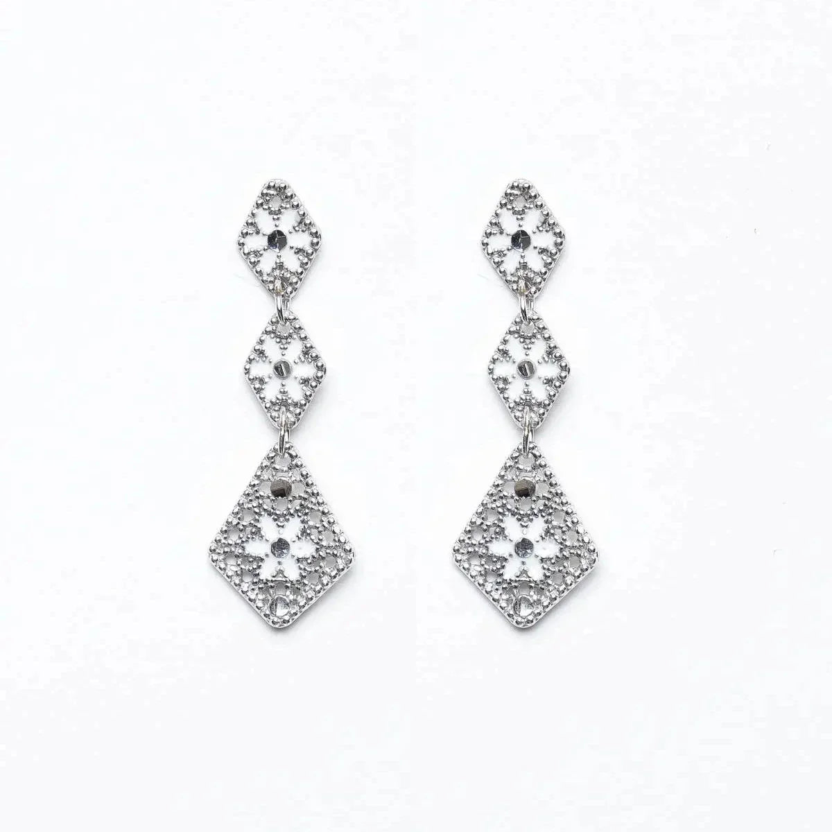 Rhodium geometric drop earrings with intricate floral and beadwork design on white background